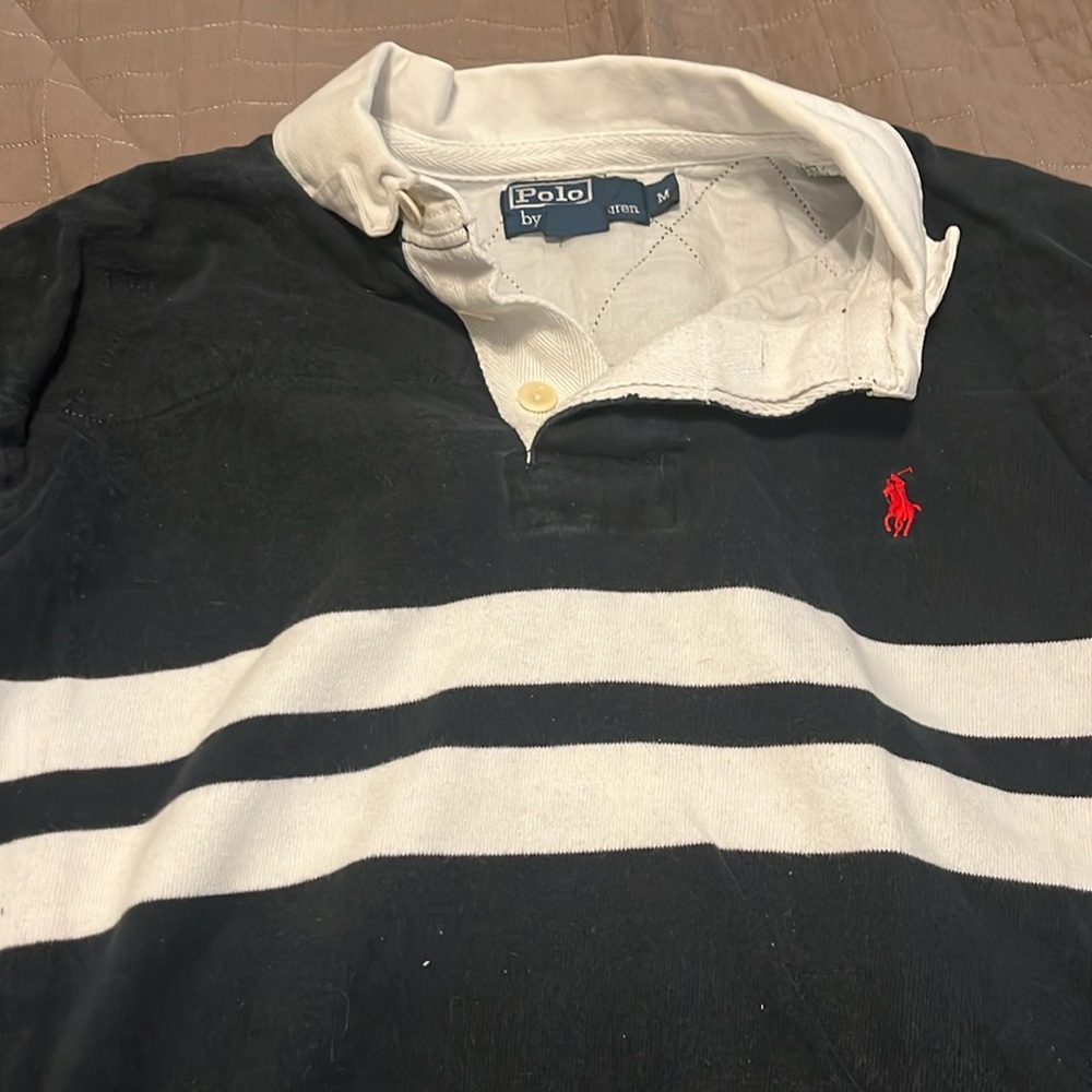 Used black long sleeved polo size M.